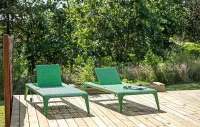two green chairs sitting next to each other on a deck at 3 Bedroom Beautiful Home In Løgstør in Løgstør