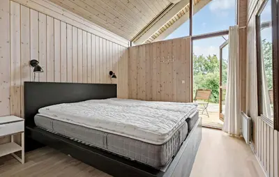 a bedroom with a bed and a large window at 3 Bedroom Beautiful Home In Løgstør in Løgstør