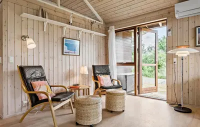 two chairs and a table in a room with wooden walls at 3 Bedroom Beautiful Home In Løgstør in Løgstør