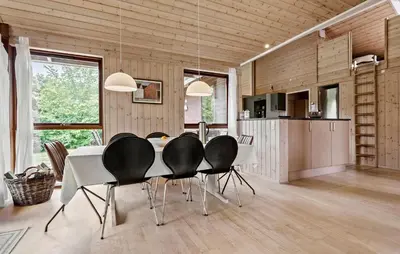 a dining room with a white table and black chairs at 3 Bedroom Beautiful Home In Løgstør in Løgstør
