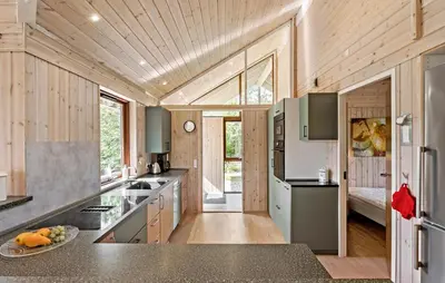 a kitchen with wood paneled walls and a wooden ceiling at 3 Bedroom Beautiful Home In Løgstør in Løgstør