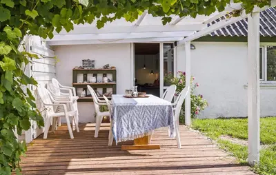 a table and chairs on a wooden deck at Nice Home In Harboøre With Wifi in Harboør