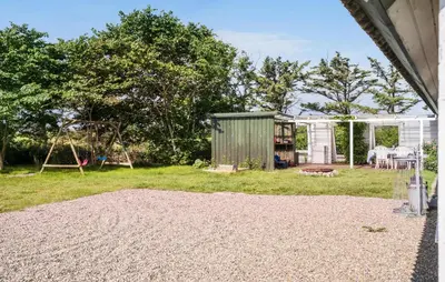 a backyard with a shed and a playground at Nice Home In Harboøre With Wifi in Harboør