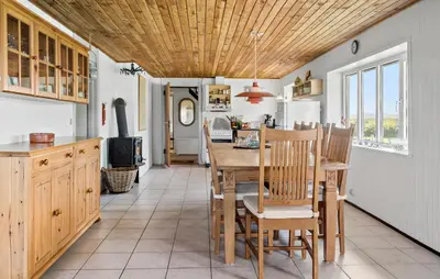 a kitchen and dining room with a table and chairs at Nice Home In Harboøre With Wifi in Harboør