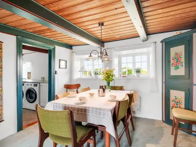 a dining room with a table and chairs at Holiday Home Vili - 100m from the sea by Interhome in Lemvig