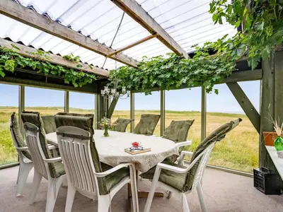a dining room with a table and chairs at Holiday Home Vili - 100m from the sea by Interhome in Lemvig