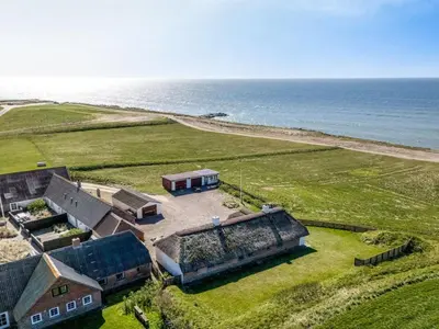 an aerial view of a house next to the ocean at Holiday Home Vili - 100m from the sea by Interhome in Lemvig