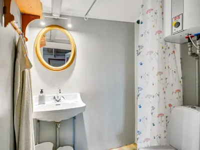 a bathroom with a sink and a mirror at Holiday Home Vili - 100m from the sea by Interhome in Lemvig