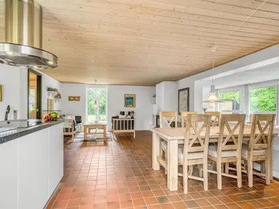 a kitchen and dining room with a table and chairs at Holiday Home Lyra - 500m to the fjord by Interhome in Øsløs
