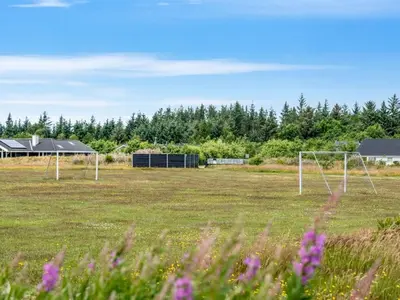 two soccer goals in a field with trees in the background at Holiday Home Lissi - 3-5km from the sea by Interhome in Brovst
