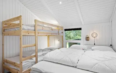 a bedroom with two bunk beds and a window at Awesome Home In Løkken With Kitchen in Løkken