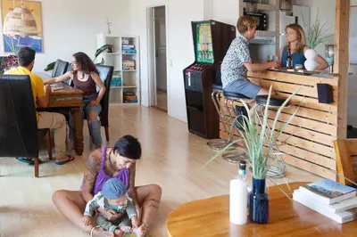 a woman holding a baby in a living room at Stone MT Garden Pod in Snedsted