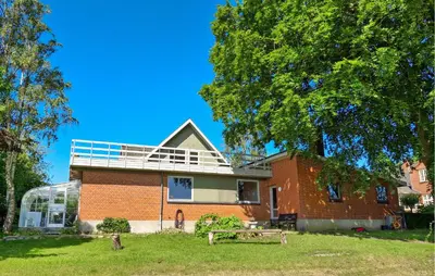 a brick house with a balcony on top of it at 2 Bedroom Stunning Home In Erslev in Erslev