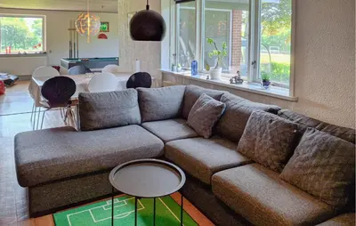 a living room with a couch and a table at 2 Bedroom Stunning Home In Erslev in Erslev