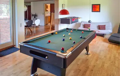 a living room with a pool table with balls on it at 2 Bedroom Stunning Home In Erslev in Erslev