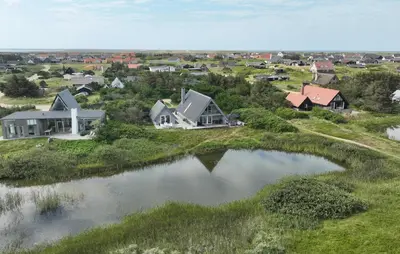 an aerial view of a neighborhood with houses and a pond at 3 Bedroom Stunning Home In Vestervig in Vestervig