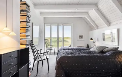 a bedroom with a bed and a desk and chairs at 3 Bedroom Stunning Home In Vestervig in Vestervig
