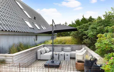 a patio with an umbrella and couches and chairs at 3 Bedroom Stunning Home In Vestervig in Vestervig