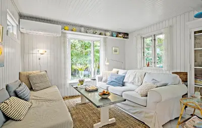 a living room with a couch and a table at Beautiful Home In Blokhus in Blokhus
