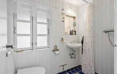a bathroom with a sink and a toilet and a shower at Beautiful Home In Blokhus in Blokhus