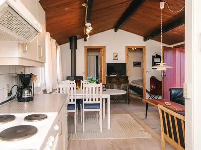 a kitchen and living room with a table and chairs at 4 person holiday home in Thisted-By Traum in Thisted