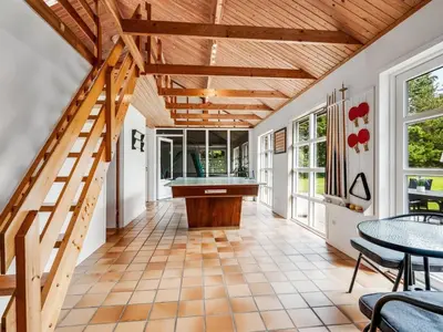 a hallway with a table and a pool table at Holiday Home Aisling - 700m from the sea by Interhome in Brovst