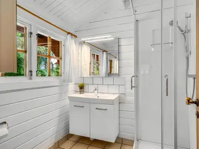 a bathroom with a sink and a shower at Holiday Home Aisling - 700m from the sea by Interhome in Brovst