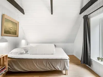 a bedroom with white walls and a bed with white sheets at Apartment Thorgot - 3km from the sea by Interhome in Pandrup