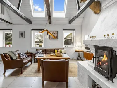 a living room with a fireplace at Apartment Thorgot - 3km from the sea by Interhome in Pandrup