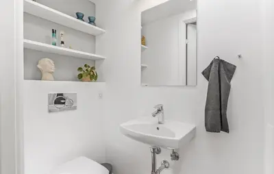 a white bathroom with a sink and a toilet at Gorgeous Home In Pandrup With Wifi in Pandrup