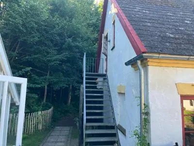a stairway leading up to a house with a roof at Krogsgaarden B&B in Nibe