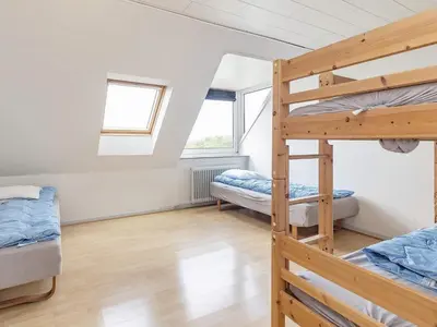 a bedroom with two bunk beds and two windows at Rustic Retreat in Gettrup - By Traum Ferienwohnungen in Sindrup