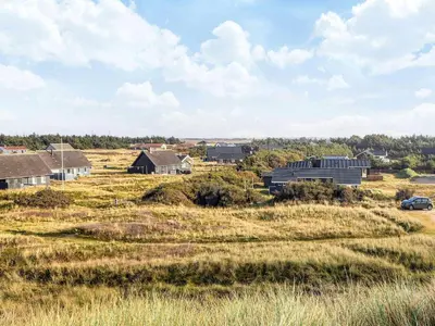 a house in the middle of a field at Seaside Escape with Swing in Vrist