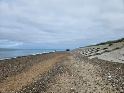 a dirt road next to the ocean on a beach at Family-friendly Retreat near Beach - By Traum Ferienwohnungen in Lild Strand