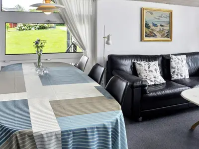 a living room with a table and a couch at 6 person holiday home in Struer-By Traum in Remmer Strand