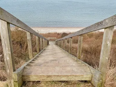 a wooden boardwalk leading to the beach at 6 person holiday home in Struer-By Traum in Remmer Strand