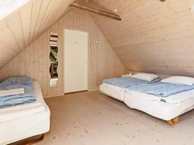 two beds in a room with a attic at 10 person holiday home in Vinderup-By Traum in Vinderup