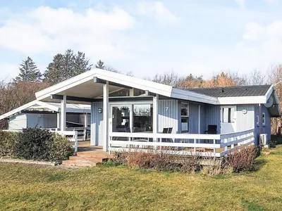 a blue and white house with a yard at 6 person holiday home in Spøttrup-By Traum in Lihme