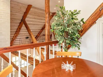 a dining room with a table and a staircase at 8 person holiday home in Løgstrup-By Traum in Hjarbæk
