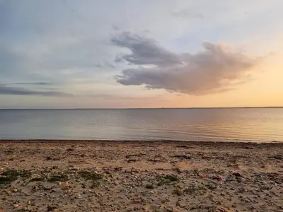 a beach with a cloudy sky and the ocean at 8 person holiday home in Spøttrup-By Traum in Lihme