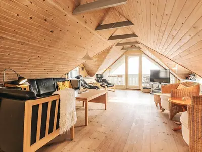 a living room with a couch and a table at 10 person holiday home in Fur-By Traum in Fur