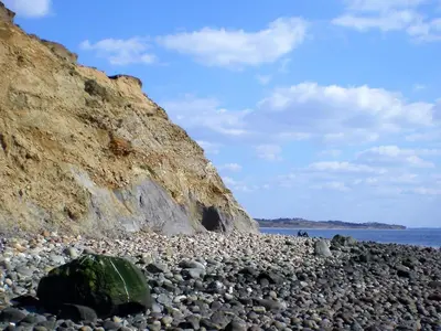 a large rock on a rocky beach next to the ocean at 6 person holiday home in Spøttrup-By Traum in Lihme