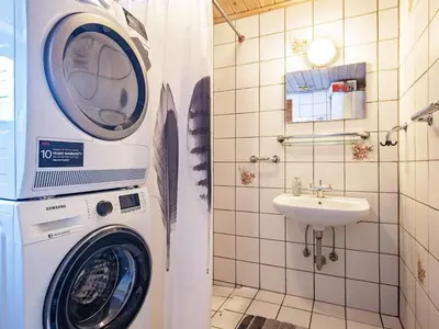 a washing machine in a bathroom with a sink at 12 person holiday home in Pandrup-By Traum in Rødhus