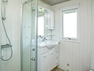 a white bathroom with a sink and a shower at 6 person holiday home in Pandrup-By Traum in Rødhus