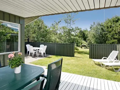 a patio with a table and chairs and a fence at 6 person holiday home in Pandrup-By Traum in Rødhus