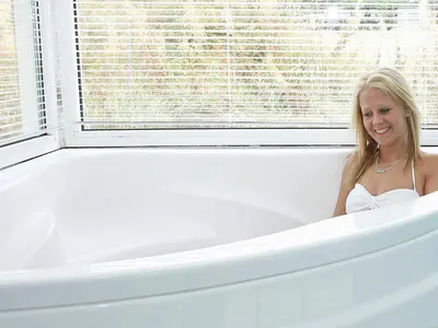 a woman is sitting in a bath tub at Luxury Pool Villa Retreat - By Traum Ferienwohnungen in Blokhus