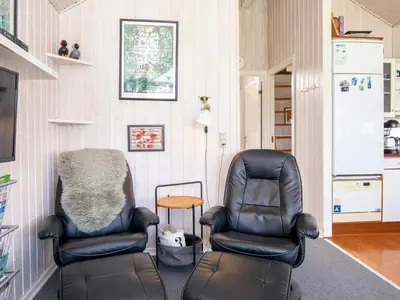 two black chairs sitting in a room with a table at 4 person holiday home in Lemvig-By Traum in Lemvig