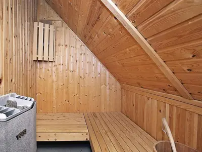 a sauna with wooden walls and a wooden ceiling at Panoramic Sea View Retreat - By Traum Ferienwohnungen in Blokhus
