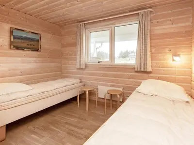 a room with two beds and a window at 10 person holiday home in Thisted-By Traum in Klitmøller