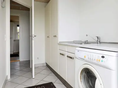 a white laundry room with a washing machine at 8 person holiday home in Vestervig-By Traum in Vestervig